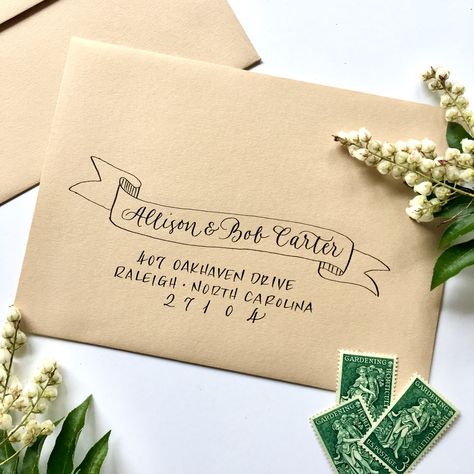 Use a ribbon banner to highlight your guests’ names on their invitation envelope. Envelope Handwriting, Hand Decorated Envelopes, Envelope Design Christmas, Mailing Envelope Design, Cricut Envelope Addressing, Envelope Calligraphy, Envelope Addressing Creative, Envelope Addressing, Envelope Decorating Ideas