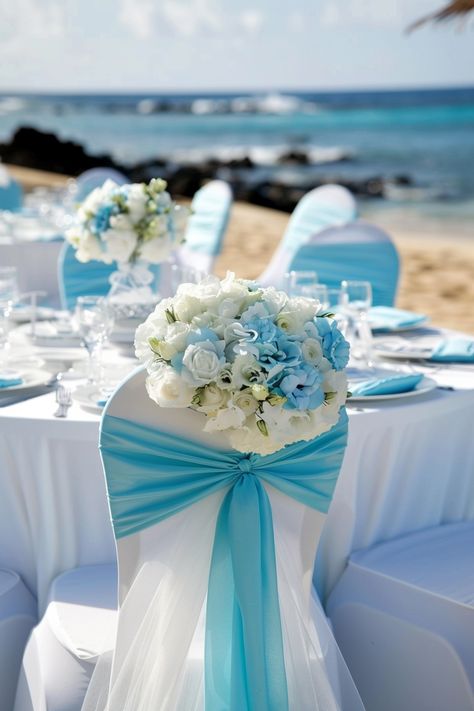 Dive into a sea of love with an oceanic touch! 💙 Our coastal-influenced wedding setup evokes the serenity of the beach using pristine whites and a spectrum of blues. Perfect for your I dos by the shore or to bring that seaside charm inland. #WeddingInspiration #BeachWedding #BlueAndWhite #WeddingDecor #ChairCovers #Sashes #CoastalChic #OceanWedding Wedding Chair Decor, Blue Wedding Theme, Blue Beach Wedding, Sea Of Love, Wedding Ambiance, Wedding Setup, Ocean Wedding, Wedding Chair Decorations, Chair Decor