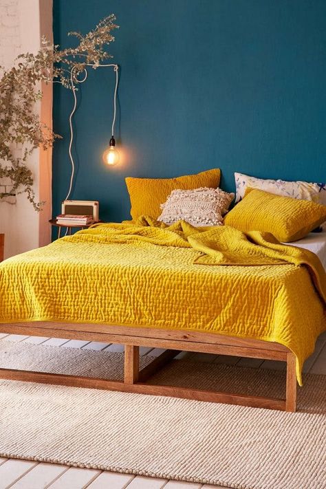 18 Ways to Decorate With the New Ochre Color Trend | Brit + Co Yellow Bedspread, Yellow Room, Yellow Bedroom, Blue Living Room, Awesome Bedrooms, Retro Home Decor, Blue Bedroom, Retro Home, Aesthetic Bedroom