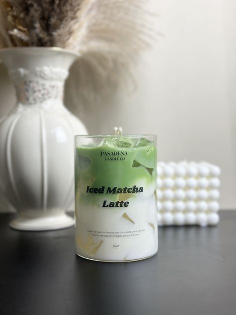 Introducing the Pasadena Candle Co. Iced Matcha Latte Candle, now available for pre-order! This exquisite candle captures the refreshing and invigorating aroma of a perfectly brewed iced matcha latte. Scent Notes: - Top: Fresh Matcha, Green Tea Leaves - Middle: Creamy Milk, Vanilla Bean - Base: Light Honey, Sweet Sugar Immerse your space in the calming and uplifting scent of matcha, creating an atmosphere of tranquility and rejuvenation. Perfect for any occasion, this candle is a must-have for matcha lovers and those who appreciate unique, realistic scents. It also makes the perfect gift for friends, family, or any candle enthusiast. Secure your Iced Matcha Latte Candle today and be the first to enjoy this delightful fragrance! Pasadena Candle Co is a perfect gift store when you think abou Matcha Candle, Latte Candle, Candles Design, Realistic Candles, Drink Candles, Green Candles, Iced Matcha Latte, Gel Candles, Tea Candle