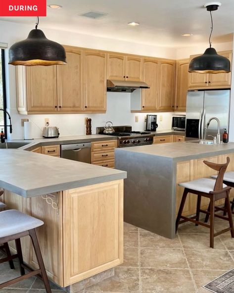 Kitchen Design With Concrete Countertops, White Cabinets With Concrete Countertops, Early 2000s Kitchen, Concrete Look Countertops, 2000s Kitchen, Concrete Kitchen Countertops, Black Pendant Lights, No Upper Cabinets, Concrete Counters