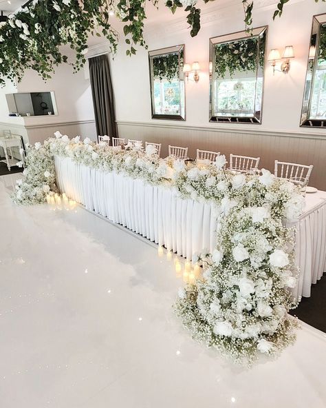 So many little dazzling crystals hanging down from our low and high floral table decor 🤍 For our amazing couple Joanne and Edwin! #weddingflowersdecoration #flowersforwedding #luxuryweddingflowers #weddingfloristry #tablecentrepiece #eventflorals #weddingflorists #flowercenterpiece #flowerdecorations #flowersdecoration #weddingceremonydecor #weddingflowerideas #weddingspecialist #eventstylists #floraldesigners #weddingflowerinspiration #flowersarrangement #luxuryfl Venue • @poetslane Flor... Wedding Main Table Decor, Wedding Top Table Flowers, Head Table Flowers, Bride Table, Main Table Wedding, Top Table Flowers, Head Table Wedding Decorations, Floral Table Decor, Faux Flowers Wedding