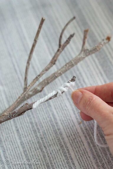 These yarn-wrapped branches are easy to make and can be used to decorate mantels or side tables. These decorative branches are perfect for your winter home decorating. He almost threw them away!Twice! You see I gather stuff. I can go for a walk, just an easy stroll through the neighborhood, an everyday walk so to speak.And come back with my pockets full of finds.Someday finds.Little treasures that have great potential for beautiful creations.I can see it in my mind: the possibilities… Tree Branch Decor Diy, Diy Yarn Decor, Tree Branch Crafts, Knitted Heart Pattern, Decorative Branches, Wrapped Sticks, Yarn Trees, Tree Branch Decor, Fiber Art Wall Hanging