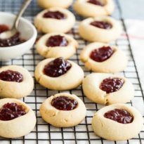 Tender-crisp and buttery, these Thumbprint Cookies can be filled with any jam you love. A class at Christmas, they shine like gems on your cookie plate! Christmas Party Menu, Christmas Casserole, Thumbprint Cookies Recipe, Cookie Plate, Easy Sugar Cookies, Cooling Rack, Thumbprint Cookies, Christmas Sugar Cookies, Party Menu