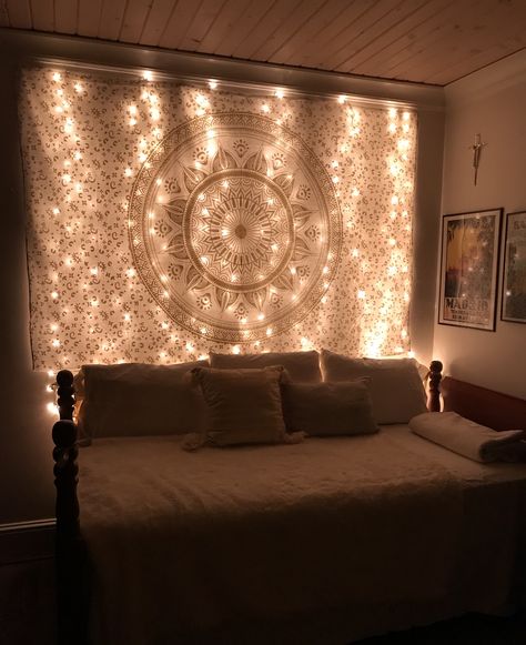 fairy lights + boho bedroom + mandala + gold aesthetic Fairy Lights Boho Bedroom, Mandala Tapestry Bedroom Aesthetic, Boho Bedroom Fairy Lights, Fairy Lights Over Tapestry, Boho Bedroom With Tapestry, Tapestry Fairy Lights, Rose Gold Boho Bedroom, Tapestry With Fairy Lights, Mandala Bedroom Ideas