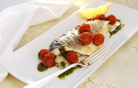 Grilled fillets of sea bass with herb risotto, roasted cherry tomatoes and pesto Grilled Sea Bass Fillet Recipes, Grilled Sea Bass Recipes, Sea Bass Fillet Recipes, Herb Risotto, Grilled Sea Bass, Bakewell Tart Recipe, Triple Cooked Chips, Sea Bass Recipe, Bass Recipe