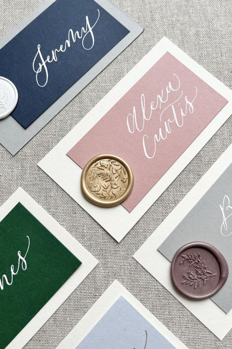 Close up of layered cardstock wax seal place cards in variety of colors Placecards Wedding Wax Seal, Wax Seal Place Cards, Placecards Wedding, Calligraphy Place Cards, Wedding Wax Seal, Wedding Graphics, Table Assignments, Wedding Party Table, Bday Cards