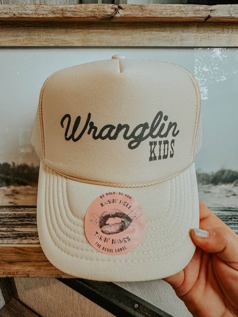 Stylish and fun, the "Wranglin' Kids Hat" adds boho western flair to any outfit. Perfect for adventurous families. Shop The Bevel Label now! All Hat No Cattle, Womens Hunting Hat, Western Outfit Accessories, Western Trucker Hat Outfit, Brand Merch Ideas Products, Baseball Mom Trucker Hat, Mama Trucker Hat, Boutique Items To Sell, Women Trucker Hat