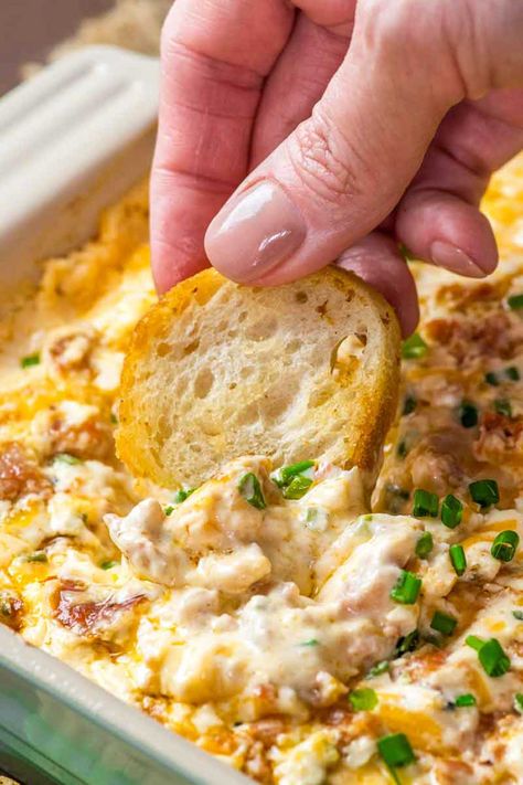 Boudin Dip! This Louisiana-inspired Boudin dip is baked hot and bubbly with spicy Boudin Cajun sausage, a mix of cheeses, and sour cream. Perfect for parties or game day! | HomemadeHooplah.com Boudin Dip Cream Cheese, Cajun Finger Foods, Cajun Finger Foods For Party, Cajun Appetizers Louisiana Finger Foods, Boudain Dip, Boudain Dip Recipe, Boudin Dip Recipe, Cajun Dip, Boudin Dip