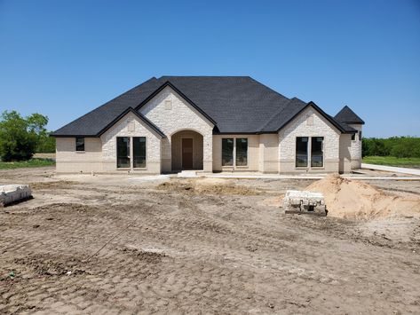 Silverado brick and Austin stone with a black roof make a stunning look. White Brick Black Roof House, White Austin Stone House Exterior, Austin Stone House Exterior, Limestone Ranch House Exterior, Stone House With Metal Roof, Brick And Rock House Exterior Farmhouse, Austin Stone Exterior, Brick And Stone House Exterior, Stone And Brick House Exterior