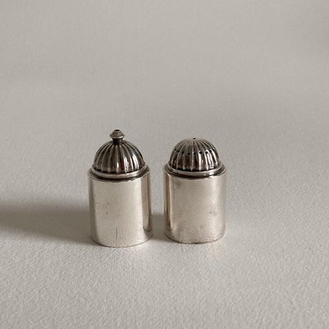 A set of sterling silver salt and pepper shakers by the Danish silver company, Georg Jensen, in a modern, streamlined, art deco pattern. Pattern designed Circa 1930.  Exact date of production unknown.  Salt and pepper shakers are in overall good condition with signs of wear/ age present on each piece. Each piece bears a “GI” Georg Jensen hallmark. Please see Condition Report below for specifics.  Perfect to use or gift for a special occasion such as a wedding, anniversary, birthday, graduation, Silver Salt And Pepper Shakers, Silver Wedding Decorations, Hugging Salt And Pepper Shakers, Vintage Salt And Pepper Shakers Antiques, Vintage Salt And Pepper Shakers 1950s, Deco Pattern, Art Deco Pattern, Silver Dollar, Vintage Objects