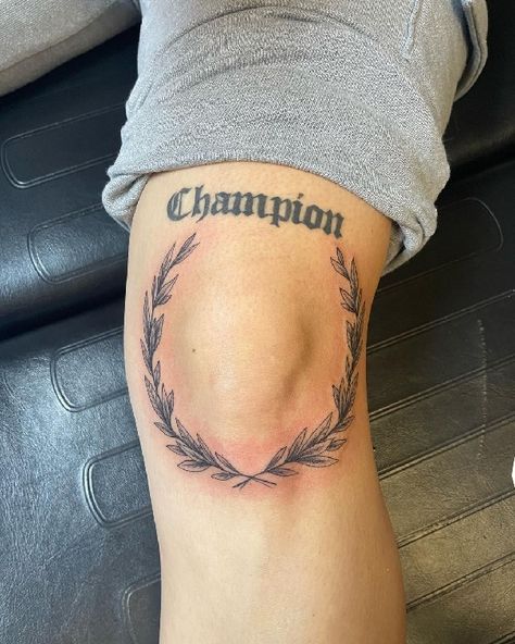 Champion Tattoo Ideas, Wreath Around Knee Tattoo, Knee Vines Tattoo, Wreath Knee Tattoo, Knee Injury Tattoo, Knee Laurel Tattoo, Vine Kneecap Tattoo, Olive Branch Tattoo Mens Knee, Around The Knee Tattoo Men