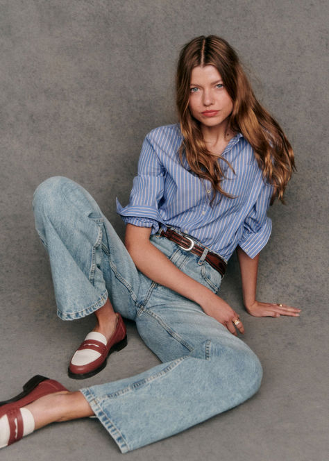 The Sézane Tomboy Shirt in Blue Stripes is a quintessential piece for a polished yet relaxed look. Featuring long sleeves, a chest pocket, and a classic collar, this straight-fit shirt is crafted for effortless style and versatility. Ideal for layering or wearing solo, it’s a timeless addition to any wardrobe. Shop the Tomboy Shirt and more at sezane.com or via the app.​ Mules Outfits, Brunch Looks, Button Down Outfit, Tomboy Shirts, French Icons, Brown Loafers, Fall Winter 2024, Cropped Trousers, Cozy Knits