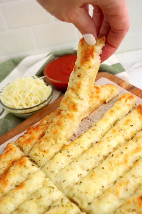 Homemade Cheesy Breadsticks - Delicious garlic pizza crust breadsticks brushed in buttery garlic and layered with cheese. Melty, bubbly, cheesy perfection! Cheesy Garlic Bread Sticks Recipe, How To Make Cheese Bread Sticks, Marcos Pizza Cheesy Bread, Garlic Bread With Pizza Crust, Garlic Bread Pizza Crust, Cheesy Garlic Pizza Bread, Pizza With Cheese Crust, Copycat Pizza Hut Cheese Sticks, Garlic Bread Sticks Pizza Dough