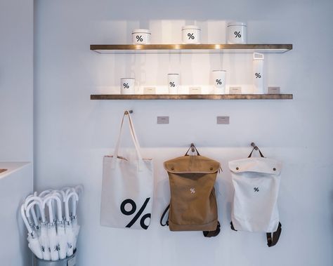 Arabica coffee shop in Hong Kong, interior view of merchandise wall Cafe Merchandise Display, Coffee Shop Merchandise Ideas, Coffee Shop Merchandise Display, Coffee Shop Merchandise, Cafe Merchandise, Kong Kong, Coffee Minimalist, Expo Display, Coffee Merchandise