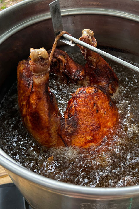 A turkey submerged in hot oil inside a deep fryer, showing the process of achieving a crispy and deliciously golden skin for a Thanksgiving meal. Deep Fry Turkey, Frying Turkey, Frying A Turkey, Juicy Thanksgiving Turkey, Smoked Turkey Rub, Fry Turkey, Deep Fried Turkey Recipes, Turkey Injection, Turkey Rub