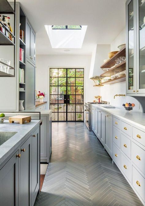 Bright galley style kitchen with gray herringbone floors, brass hardware, skylight, and floating shelves. Small Galley Kitchen Designs, Long Narrow Kitchen, Best Flooring For Kitchen, Galley Kitchen Design, Galley Kitchen Remodel, Galley Style Kitchen, Brooklyn Brownstone, Narrow Kitchen, Shaker Style Kitchens