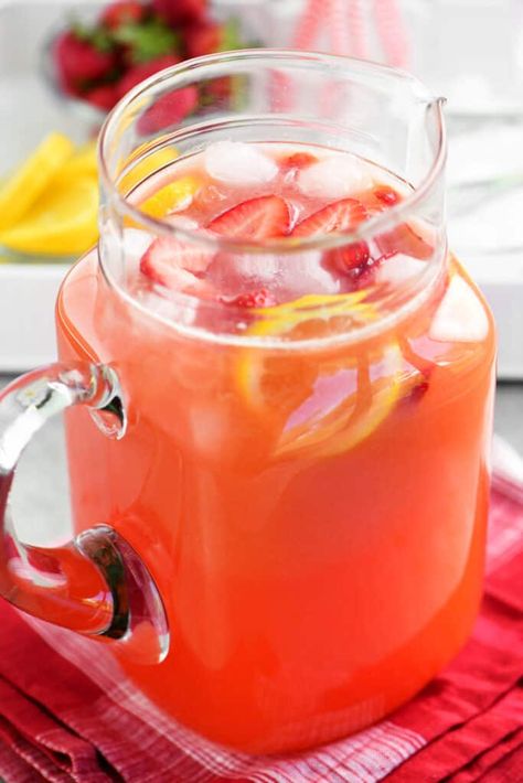 This homemade Strawberry Lemonade recipe is sweet, tart, and so refreshing! You'll want to keep a pitcher in the fridge all summer long. Gallon Lemonade Recipe, Freckled Lemonade, Homemade Strawberry Lemonade Recipe, Pineapple Rum Punch, Sherbet Punch Recipes, Passion Tea Lemonade, Homemade Strawberry Lemonade, Strawberry Lemonade Recipe, Sweet Tea Recipes