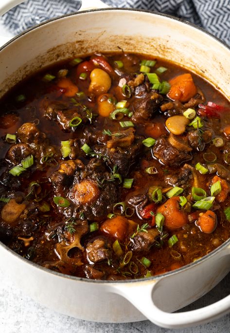 Jamaican Oxtail Stew Recipe + VIDEO - This Jamaican-style oxtail soup recipe is fantastically easy to prepare on the stovetop, or in a slow cooker or Instant Pot. It features fresh veggies and kick of spice for a rich and savory, delicious and comforting dish! | A Spicy Perspective Oxtail Slow Cooker, Oxtail Soup Recipe, Oxtail Recipes Easy, Jamaican Oxtail Stew, Cooking Oxtails, Oxtail Stew Recipe, Ox Tails, Oxtail Recipe, Jamaican Oxtail