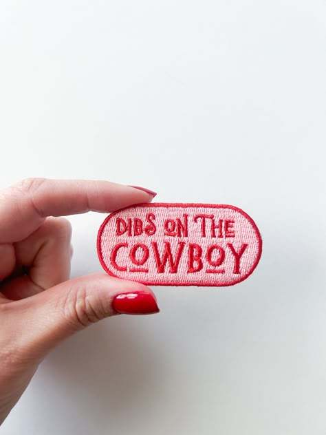 "Product Details: Size: 1 1/4 inched by 2 1/2 inches Design: Bold Pink and Light Pink Material: High-quality embroidered fabric Description: Make your intentions known with our \"Dibs on the Cowboy\" Embroidered Iron-On Patch! This playful and cheeky patch lets everyone know that you've staked your claim on the cowboy of your dreams. Perfect for cowboy enthusiasts and those with a sense of humor, this patch adds a touch of fun to your clothing, bags, or accessories. 🤠💘 Claim Your Cowboy: Declare your affection with this charming embroidered patch! The phrase \"Dibs on the Cowboy\" lets the world know that your heart belongs to your favorite cowboy, adding a touch of romance and humor to your style. 🌟 Perfect for Western Romance: Whether you're dreaming of a cowboy romance or already hav Dibs On The Cowboy, Hat Bar, Cowboy Love, Retro Cowboy, Cowboy Romance, Cowboy Gifts, Cowboy Design, Western Romance, Outlaw Country