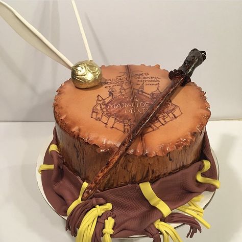 Harry Potter cake Gryffindor maroon and gum paste golden snitch gum paste wand marauders map Harry Potter Cake Gryffindor, Sweet 16 Birthday Cake, 16 Birthday Cake, Marauders Map, Harry Potter Cake, Golden Snitch, 16 Birthday, Baby Gender Reveal, Sweet 16 Birthday