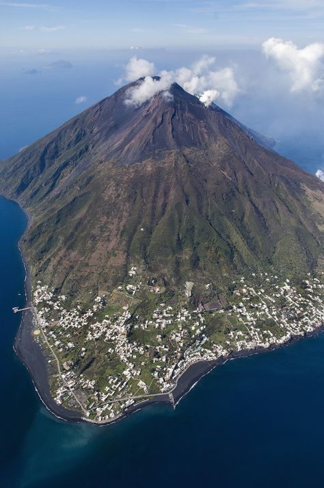 Trip to an active volcano anyone? Stromboli, just off the northern coast of Sicily, is one of Italy’s eight Aeolian Islands and one of its three active volcanoes. It’s constantly active and its fiery mouth is often visible a distance, which explains its nickname – ‘The Lighthouse of the Mediterranean’. Stromboli Italy, Island Bucket List, Stromboli Volcano, Aeolian Islands, Old Fort, Active Volcano, The Lighthouse, Landscape Pictures, Messina