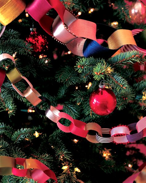 DIY Christmas Tree Garland Ideas to Personalize Your Holiday | Sorry tinsel, your time is over. These festive embellishments are the perfect garland to adorn your Christmas tree. Here's a cost-effective recyclable option: use paper ribbons from gifts to craft this decorative chain-and keep adding for years to come!  #christmas #crafts #marthastewart #DIYdecor Christmas Tree Ribbon Garland, Christmas Tree Garland Ideas, Diy Christmas Tree Garland, Tree Garland Ideas, Garlands Christmas, Diy Garlands, Garland Ideas, Diy Christmas Garland, Christmas Garlands