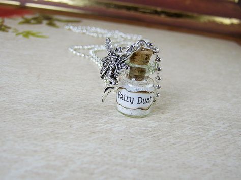 Small (0.5ml) glass bottle pendant filled with fairy dust, with silver fairy charm.  Available in 19 colors: White (Default), Black, Blue, Baby blue, Dark blue, Glow-in-the-dark, Gold, Emerald green, Light green, Lilac, Orange, Hot pink, Light pink, Pink-based multi-color, Purple, Purple-based multi-color, Ruby red, Silver, and Yellow.  ** Also available in custom colors! Need a solid color (e.g., pastel purple or burnt orange); or want a custom mix (e.g., yellow and red or black and green)? ... Vial Pendant, Glass Bottle Necklace, Fairy Things, Magic Dust, Silver Fairy, Violet Pastel, Pixies Fairies, Fairy Charms, Bottle Pendant