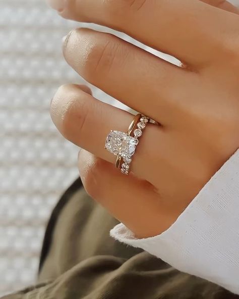 Nuno Rocha on Instagram: "Sparkling with love and elegance, this engagement ring features a stunning 2.00ct elongated cushion cut diamond set on a plain 1.50mm tube shank. Paired perfectly with a shared bead wedding band for a timeless look. 💍💖 #EngagementRingGoals   Do you all love how I paired the engagement ring!?  —————————————- - 2.01ct Elongated Cushion Cut  - E colour VS1 Clarity  - 1.50mm Tube - 1.25% Ratio  - 18KT yellow  Gold - GIA Certified  - Hand Model Size 5 —————————————-  💍Why join the @diamondboi family? At @diamondboi, we take pride in crafting custom-made rings tailored to our clients’ preferences and budgets, ensuring that every piece is a perfect fit. With our commitment to accommodating various budgets, our rings can be expertly crafted to suit a wide range of fina Wedding Band With Cushion Engagement Ring, Plain Engagement Ring With Diamond Band, Elongated Cushion Ring Set, Lab Grown Elongated Cushion, Elongate Cushion Engagement Ring, Elongated Cushion Ring With Wedding Band, Enlonged Cushion Cut Engagement Ring, Wedding Bands For Elongated Cushion, Elongated Cushion Engagement Ring And Wedding Band