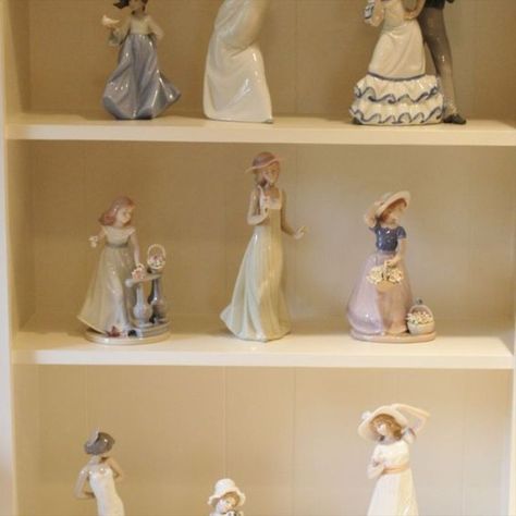 Lladro and Nadal Spanish porcelain figurines (nine) including Lladro NAO Flamenco Dancers; Lladro Curious Angel #4960; Lladro NAO Girl with Dove; NADAL girl with flower baskets; Lladro NAO Gentle Breeze #1158; NADAL girl with flowers on railing; NADAL tall woman figurine; Lladro NAO flamenco dancer; Lladro NAO seated girl holding a dog. Lladro Figurines Display, Lladro Figurines Vintage, Lladro Clown Figurines, Antique Figurines Porcelain, Lladro Figurines, Porcelain Horse Figurine, Lladro Figurines Retired Vintage, Flamenco Dancers, Flower Basket