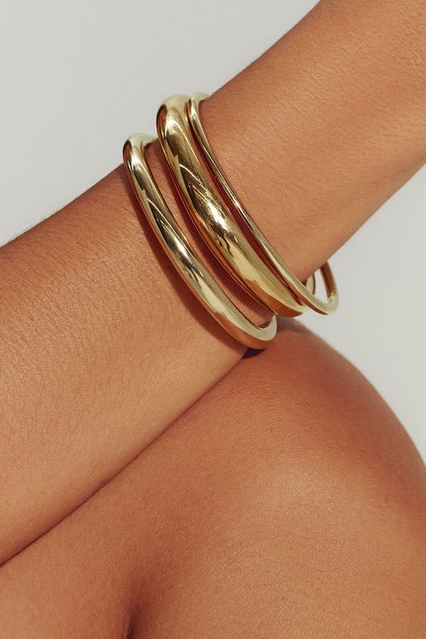 Filled with 18K gold, our Brazil-made tube cuff is the dynamic final touch – or the gleaming foundation of a sculptural bracelet stack. Mix in varying widths and finishes for the most impact. Jewelry Collection Handcrafted in Brazil 18K Gold Filled Thickness: 8.4mm Inner Diameter: 2.5" Opening: 1.25" Weight: 0.38 oz Waterproof Hypoallergenic Tan Skin Gold Jewelry, Gold Hoop Bracelet, Gold Necklace And Bracelet, Chunky Gold Bangle, Dainty Gold Jewelry Bracelets, Gold Bracelet Thick, Gold Bracelets Bangles, Big Gold Bangles, Gold Jewelry Display