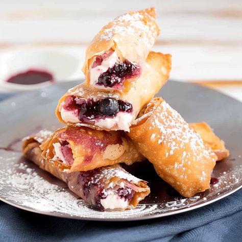 Indulge in the sweet fusion of flavors with our "Berry Swirl" Blueberry Cream Cheese Egg Rolls, a creative dessert that wraps the creamy, tangy taste of blueberry cream cheese filling inside a crispy, golden egg Blueberry Cream Cheese Filling, Cream Cheese Egg Rolls, Cheese Egg Rolls, Egg Roll Ingredients, Whipped Shortbread, Whipped Shortbread Cookies, Berry Sauce, Blueberry Compote, Blueberry Sauce