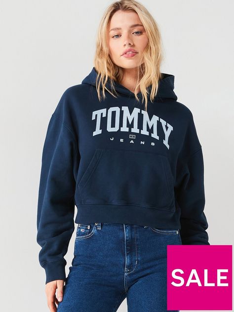 Tommy Jeans Varsity Logo Cropped Hoodie Size & Fit Boxy fit Cropped length Available in sizes S-XL (S: UK 8, M: UK 10, L: UK 12, XL: UK 14) Model is 5'8" and wears a UK size 8 Details Varsity Logo Cropped Hoodie by Tommy Jeans Navy Soft, breathable cotton fabric Tommy Jeans branding to the chest  Fixed hood  Front kangaroo pocket Dropped shoulder seams  Long sleeve Ribbed cuffs and hems Material & Care Material Content: 100% Cotton Tommy Jeans Hoodie, Five Jeans, Jeans Hoodie, Varsity Hoodie, Hoodie Jersey, Tommy Hilfiger Logo, Navy Hoodie, Sweat Hoodie, American Brand