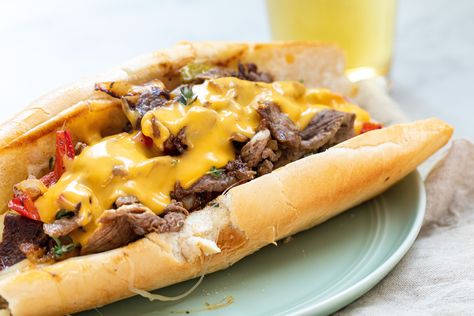 This recipe will transport you right to Philadelphia—this classic Philly Cheesesteak is packed to the brim with thinly sliced steak, onions, provolone cheese, and Cheez Whiz. Learn how to make fantastic homemade cheesesteaks and make them whenever you want! Philly Cheese Steak Sandwich, Kinds Of Steak, Cheez Whiz, Philly Cheese Steak Recipe, Cheese Whiz, Steak And Onions, Cheesesteak Recipe, Cheese Steak Sandwich, Steak And Mushrooms