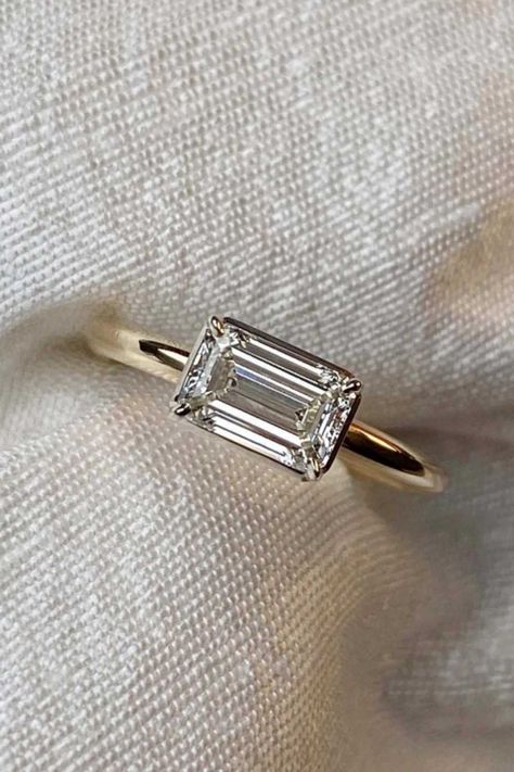 Crux signature East-west elongated emerald cut diamond engagement ring with a 18ct yellow gold band, framed in a contemporary platinum setting. Different Engagement Rings, Wedding Rings Emerald Cut, Beautiful Gold Rings, Emerald Cut Diamond Engagement Ring, Cute Engagement Rings, Future Engagement Rings, Yellow Engagement Rings, She Said Yes, Emerald Cut Rings