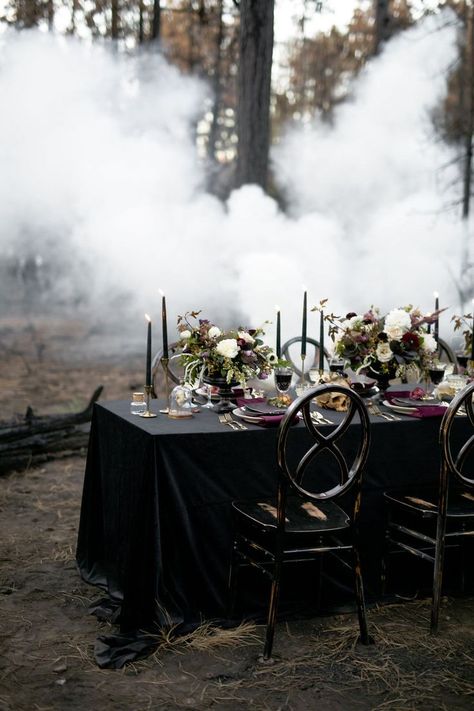 Dark and moody wedding reception tablescape with black table cloth, dark purple tapered candles,and burgundy and white floral centerpieces.| Moody Jewel-Toned Halloween Wedding Inspiration Shoot | #equalitymindedweddings #lgbtweddingmagazine #loveinc #halloweenwedding #halloween #floralcenterpiece #moodyweddingphotography Ballet Wedding, Martha Stewart Halloween, Moody Wedding Photography, White Floral Centerpieces, Dark Wedding Theme, Gothic Floral, Halloween Themed Wedding, Reception Tablescapes, Unique Wedding Flowers