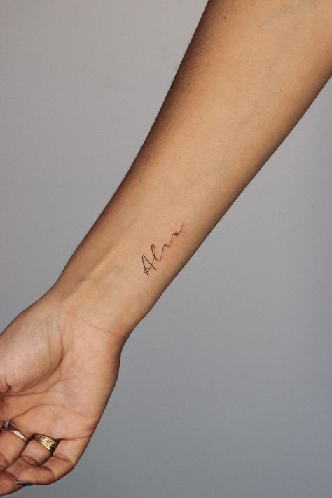 Wrist tattoo small fineline name alix Dainty Last Name Tattoo, Meet Name Tattoo, Dainty Tattoo For Son, Tattoo For Daughter Name, Mini Name Tattoo, Script Name Tattoo Forearm, Dainty Tattoo For Kids, Names On Wrist Tattoos, Child’s Name Tattoo Dainty