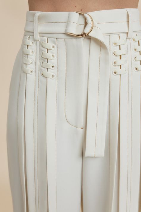 The Haywood Pant in Coconut are designed to be fitted at the waist and relaxed toward the hem. An updated suiting silhouette featuring lace up detail, soft pleats through the legs, contrast top stitching and a luxurious d-ring belt with gold hardware. Pair back with the Haywood Jacket for a complete look. - High waist fit - Full length pant - Front fly closure - Detachable belt - Vertical pleating Model is 180cm / 5'10″ wearing an AU 8 / US 4 Composition: 80% Polyester, 16% Viscose Rayon, 4% Ela Body Shape Style Guide, Clothing Hardware, Body Shape Outfits, Pear Body Shape Fashion, Pear Body Shape Outfits, Zipper Fashion, Pear Body, Pear Body Shape, Designer Pants