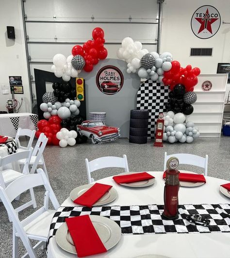 Nicole Creations Houston on Instagram: "Classic cars and dinner theme This is the coolest garage I’ve seen! My clients grandparent was awesome. He took us back to 1950s Amazing place! Baby Holmes is on his way! Thanks to Victoria and family for choosing us #eventplanner #houstondecorator #balloongarland #babyshower #kidsparty #itsaboy #classiccartheme #houstonbackdrops #elvis #1955chevybelair" Racing Theme Backdrop, Racing Theme Birthday Party Decorations, Classic Car 1st Birthday Party, Garage Theme Birthday Party, Classic Car Birthday Party Decorations, Race Track Theme Birthday Party, Large Backdrop Ideas, Classic Car Centerpieces Ideas, Racing Car Birthday Theme