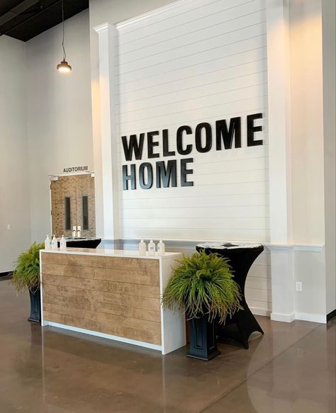 Business Entryway Ideas, Church Reception Desk, Church Foyer Decorating Ideas, Christian Church Interior Design, Welcome Desk Church, Church Cafe Ideas, Church Lobby Furniture, Church Platform Decor Ideas, Church Signage Interior