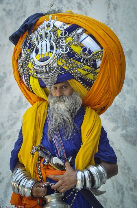 Avtar Singh is seen wearing a huge traditional Punjabi turban called 'pagdi' in the Indian town of Patiala on July 19 in Punjab. The impressive headgear weighs a hefty 100lbs and measures in at a staggering 645m when unwrapped - the same as 13 Olympic-sized swimming pools. The 60-year-old has been regularly adding to it for the past 16 years and it can take him up to six hours to put it on. His supersize turban made him one of the most respected preachers in the Pubjab, but it causes day-to-day Yoga Studio Design, Amazing India, We Are The World, Cultural Diversity, Varanasi, World Cultures, People Of The World, Incredible India, Turbans