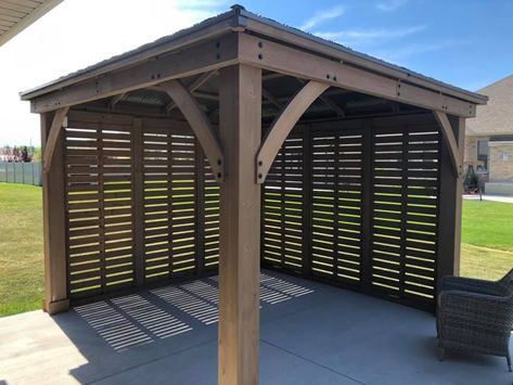 Yardistry's 12 ft. Privacy Wall is the perfect complement to your existing Yardistry 12 x 12, 12 x 14 or 12 x 16 Wood Gazebo with Aluminum Roof. Whether you’re looking for some shade, protection from the wind, or a little privacy, Yardistry’s unique privacy wall design has you covered. Pergola Wind Break, Gazebo With Privacy Screen, Diy Pergola Privacy Wall, Hot Tub Pergola Ideas Privacy Walls, Privacy Gazebo Ideas, Covered Deck With Privacy Wall, Gazebo Privacy Wall Ideas, Patio Cover With Privacy Wall, Gazebo Walls Diy