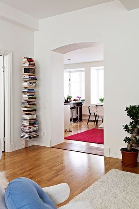 Discover how to elevate your home's organization and style with our smart vertical storage solutions! 📚✨ This clever wall-mounted book nook not only saves precious floor space but also adds a unique touch to your small living area. Tap into the full potential of every inch in your home with more innovative ideas—find out how on our latest blog post. Ready to transform your cozy corner into a masterpiece of efficiency? #GoTinySpace #VerticalStorageSolutions Wall Mounted Vertical Bookshelf, Bookshelf Invisible, Vertical Storage Ideas, Storage Solutions For Small Spaces, Invisible Bookshelf, Vertical Bookshelf, Window Shelf, Minimalist Shelves, Elevated Homes