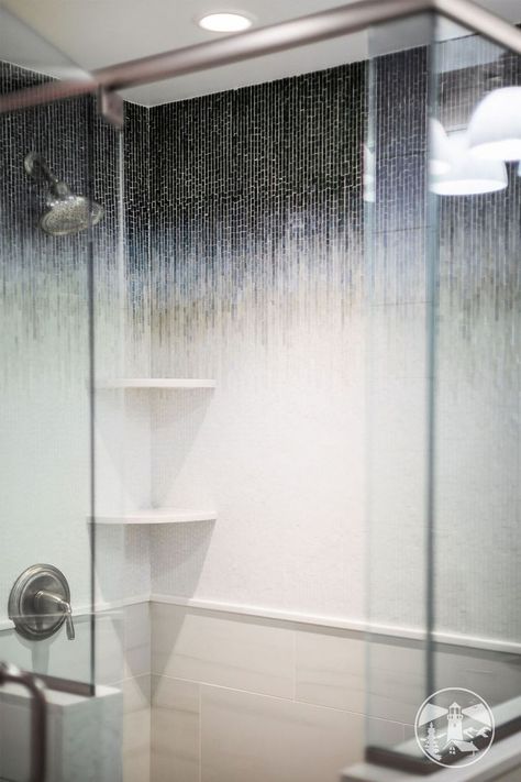 A Nantucket inspired bathroom. Complete with mosaic shower tile featuring Billie Ombre tile. Coupled with brushed satin fixtures. #guestbath #showertile #interiordesign #bathroomideas Grey Bathroom Shower Tile, Shower Tile Mosaic, Ombre Tile, Mosaic Shower Tile, Blue Bathroom Tile, House Coastal, Restroom Design, Lake Winnipesaukee, Grey Bathroom