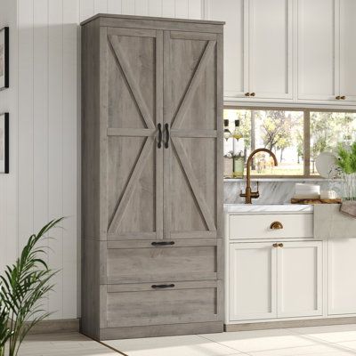 This farmhouse-inspired pantry cabinet offers ample storage and organization for your kitchen essentials. The 70" tall frame is made from engineered wood, and it features a raised slat design with a solid finish that complements your rustic decor. Its double-door cabinet houses 4 shelves, each with a weight capacity of over 33 lbs. Additionally, the middle shelf can be adjusted or removed to accommodate items of various heights. The two spacious drawers are perfect for stashing smaller items lik Food Pantry Organizing, Pantry Storage Cabinet, Door Hardware Interior, Teen Bedroom Furniture, Nursery Furniture Sets, Teen Bedding, Dog Furniture, Bedroom Furniture For Sale, Pantry Cabinet