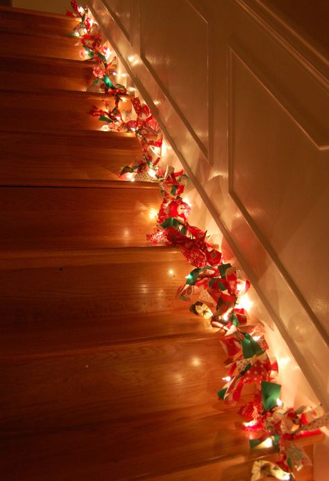 2 1/2 yards of fabric cut into 2x9 inch strips, 100 count string lights, tie 2 or 3 strips between each light Wreaths For Christmas, Lighted Garland, Rag Wreaths, Christmas Lights Garland, Stairway Lighting, Christmas Staircase, Hanging Christmas Lights, Christmas Material, Light Garland