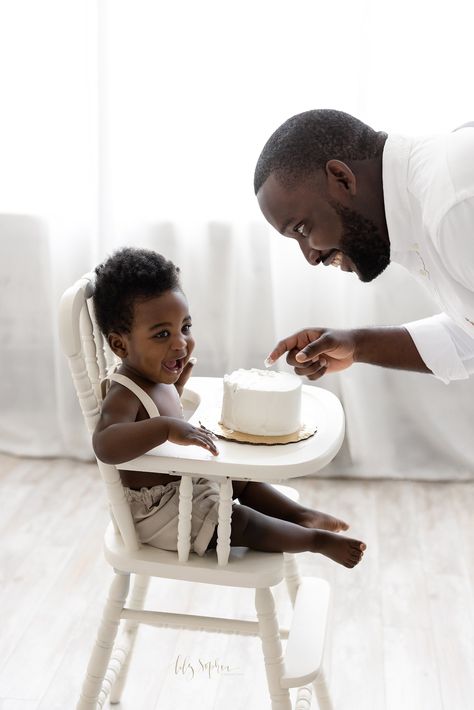 First birthday smash cake photograph of a one-year-old boy as he sits in an antique high chair in front of a natural light window with his Dad facing him with icing on the son’s and the Dad’s hands as they both laugh taken near Smyrna in Atlanta, Georgia Curly Hair Baby Boy, Natural Light Window, Antique High Chairs, Curly Hair Baby, First Birthday Smash Cake, Light Window, Birthday Smash Cake, Milestone Photography, Natural Light Studio