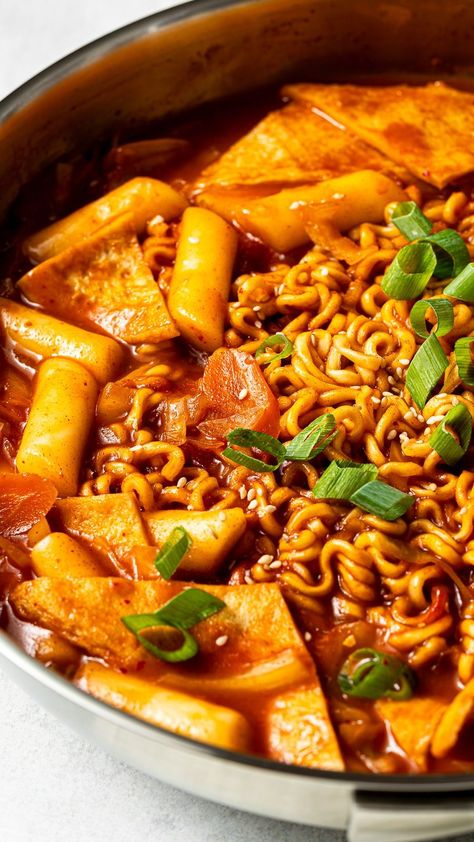 Korean rabokki is a popular dish that combines tteokbokki (rice cakes in a spicy gochujang sauce) and ramen. It also has fresh vegetables, fish cakes, fried eggs, and green onions. It's a delicious comfort food that is a must-make for anyone who loves spicy Korean foods! Korean Rabokki, Korean Food Tteokbokki Recipes, Tteokbokki With Fish Cake, Korean Tteokbokki, Tteokbokki Rice Cakes, Rice Cake Recipes Tteokbokki, Spicy Korean Food, Korean Rice Cake Tteokbokki, Korean Fish Cake