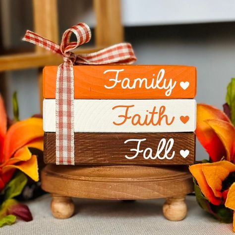 NEW BOOK STACK SIZE AVAILABLE!  This cute fall wooden book stack bundle is the perfect addition to your fall tiered tray decorations. It will bring the cozy fall feel to your home and look perfect wherever you decide to put it. Whether it be on a tiered tray, fall farmhouse mantle, bookshelf or as part of an autumn decorative centerpiece. All of our mini book stacks and larger size bookstacks are handmade & hand painted. ❤PLEASE READ DESCRIPTION, PROCESSING TIMES & ESTIMATED SHIPPING DATES IN ITS ENTIRETY.❤ ❤ SIZE: WE ARE NOT RESPONSIBLE FOR FAILURE TO READ DIMENSIONS OR PROCESSING TIMES ORIGINAL MINI BOOK STACK SIZE: 2.25" tall 3.5" wide 2.25" deep NEW LARGER BOOK STACK SIZE: 2.25" tall 5" wide 3.25" deep PLEASE REFER TO OUR SHOP BANNER PHOTO THAT SHOWS HOW THE SIZE DIFFERS. RIBBON, WORDI Books Made Out Of Wood, Wooden Book Decor, Mini Book Stacks Diy, Mantle Bookshelf, Farmhouse Mantle, Wood Books, Fall Autumn Decor, Fall Tiered Tray Decor, Faux Books