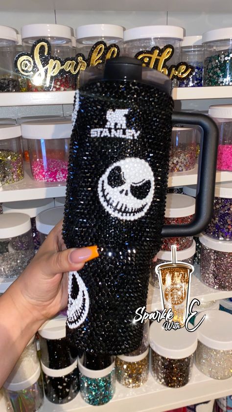 Stanley Quencher H2.0 FlowState Tumbler - 40 fl. oz.   Jack Skellington Custom  (THESE TUMBLERS ARE NOT READY TO SHIP THEY ARE MADE BY ORDER)  Custom full bling Stanley tumbler.  ( Black and white glass rhinestones) Please keep in mind processing time is a bit longer since these are very time consuming, and each rhinestone is placed one by one. All Tumblers are unique and are handmade by order so imperfections are to be expected. If you need an order sooner, please feel free to reach out as I do offer rush my order options for additional fee. Care instructions: -Please hand wash gently with soap and water -Do not leave in extreme conditions for long periods of time (ex: do not leave in a hot/cold car over night). -Do not soak -NOT microwave, oven or dishwasher safe. Jack Skellington Rhinestone Tumbler, Rhinestone Stanley Tumbler, Custom Cups Ideas, Decorated Stanley Tumbler, Halloween Stanley Cup, Customized Stanley Tumbler, Bling Stanley Cup, Custom Stanley Cup, Bedazzled Stanley Cup